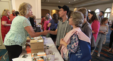 NFB members check in at a table for convention activities.